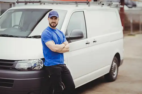 Man in front of his van