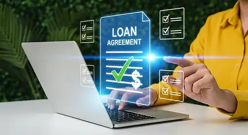 Laptop with loan agreement and a large green tick