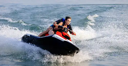 A couple riding a jetski