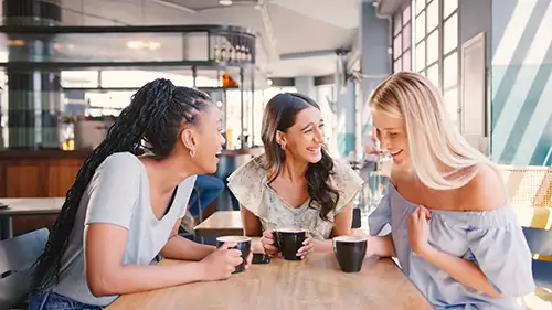 Young ladies meeting for a coffee