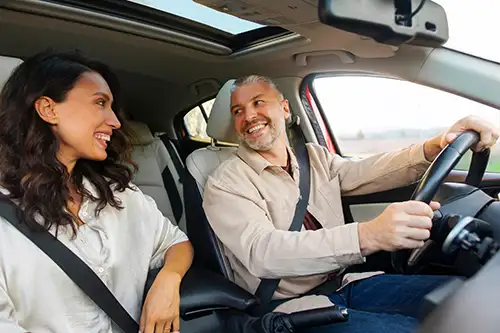Middle aged couple driving in a car
