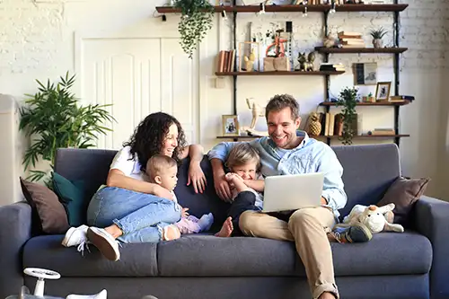 Family relaxing on the sofa in their new home