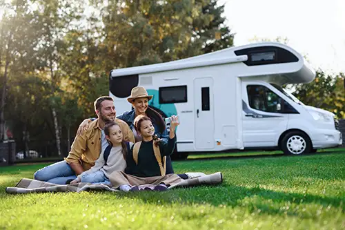 Caravan with family on the grass
