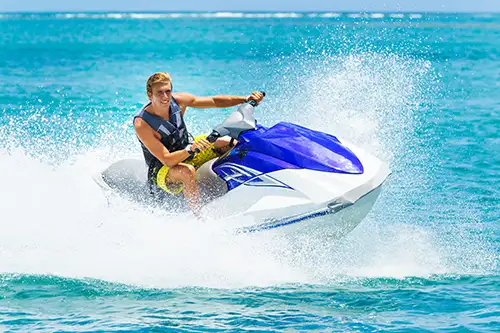 Young man enjoying a ride on his jetski