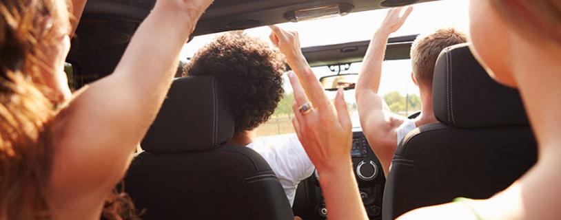 young happy friends in car