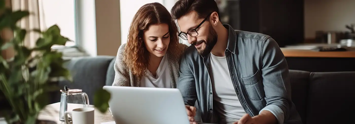 couple at home with laptop wide