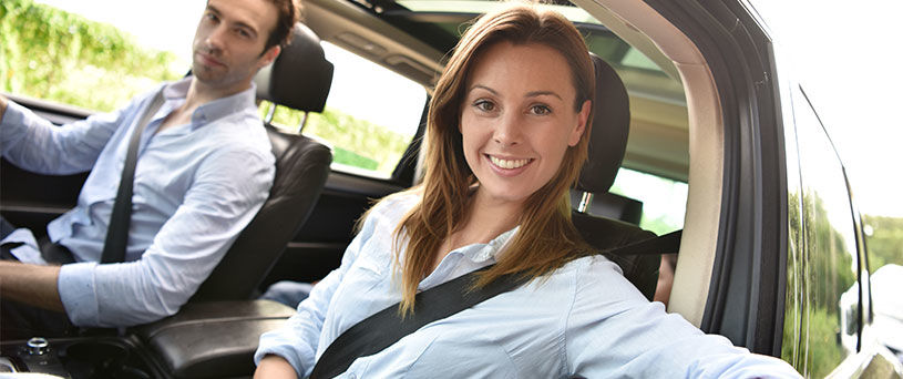 happy couple in new car