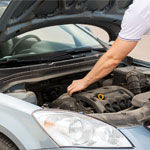 man inspecting under bonnet