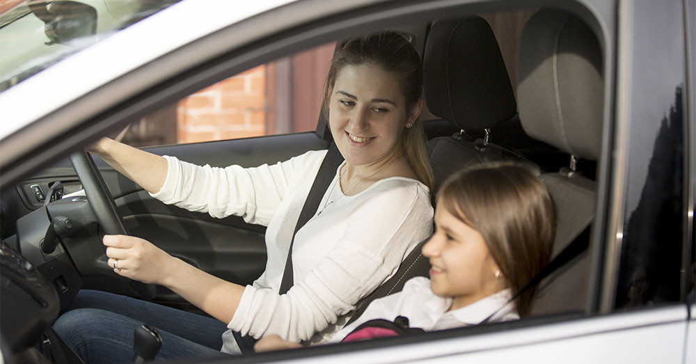 single mother driving child to school main hero