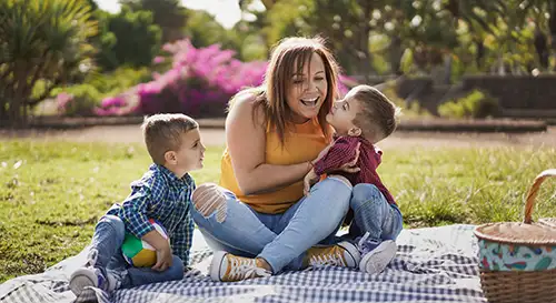 Mother with two young children in the park